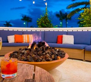 7 Reasons to Visit King and Prince's ECHO this November! a fire pit on a patio