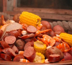 Discover Coastal Georgian Cuisine. Lowcountry Boil corn, sausage, potatoes and shrimp