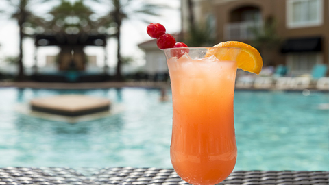Best Beach Clubs on St. Simons Island. a frozen cocktail next to a pool