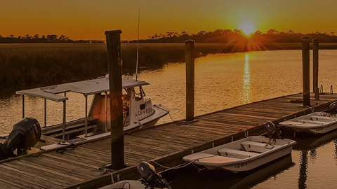 HAMPTON RIVER MARINA. a dock with 3 boats